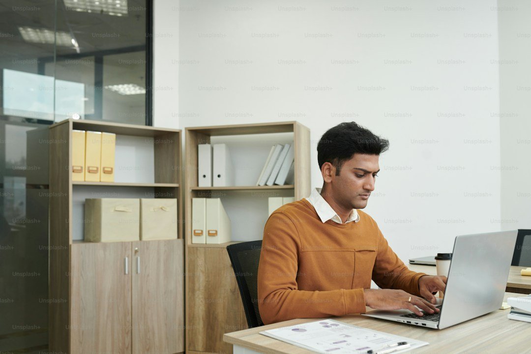 South Indian IT Professional at Work Desk